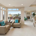 Sunlit living room with armchairs and fireplace