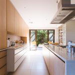 Bright modern kitchen with island and garden