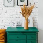 Vase of pampas grass on green dresser